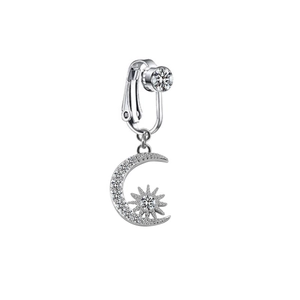 Close-up of non-piercing belly clip with silver moon and sun pendant with crystals