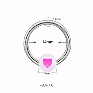 Detail view of 1.6mm captive bead ring featuring a glow heart bead and steel band