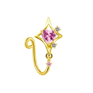 Macro detail of gold nose ring featuring a pink heart stone and starburst frame design