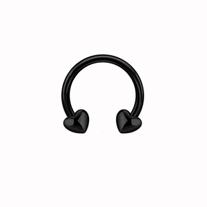 Macro view of matte black horseshoe nose ring featuring heart-shaped ends on white background