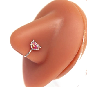 Pink heart-shaped fake nose ring in silver finish on a realistic silicone model