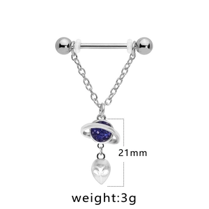 Detail view of heart zircon nipple ring with purple Saturn and alien head charms