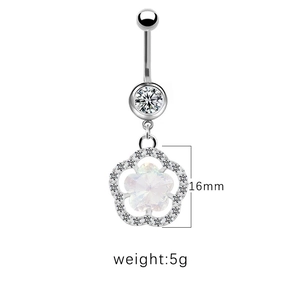 Detailed view of silver flower belly piercing with sparkling crystals and iridescent stone