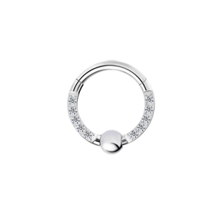 Macro shot of F136 titanium nose ring with sparkling white gems and a center ball detail