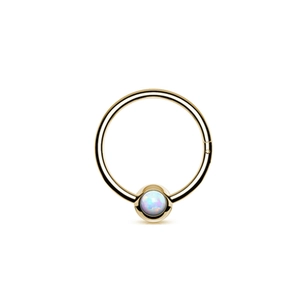Detail of gold titanium nose ring with opal bead and mirror polished surface finish