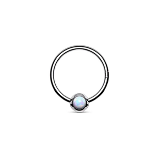 Macro view of a polished F136 titanium captive bead ring with an iridescent white opal stone