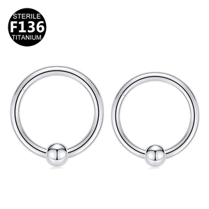 Macro detail of sterile F136 titanium captive bead rings with smooth polished finish