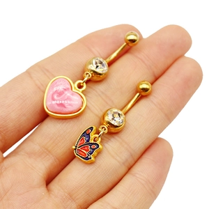 Detail view of heart and butterfly belly rings with colorful acrylic and gold plating
