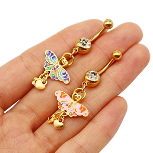 Macro view of gold butterfly navel rings with enamel wings and zirconia heart charms