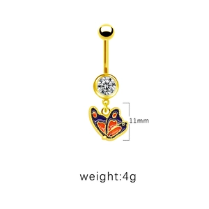 Detailed view of gold navel ring with colorful enamel butterfly and clear zircon stone