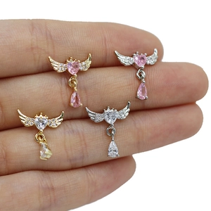 Detailed view of heart-shaped angel wing labret studs with pear-cut zircon drops