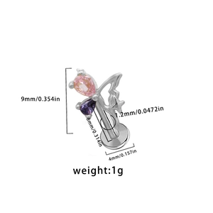 Detail view of butterfly labret stud featuring pink and purple pear-shaped zircons