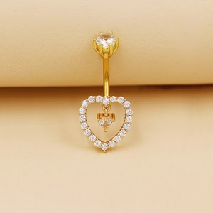 Piercing ombligo dorado con colgante de corazón y detalles en circonitas brillantes
