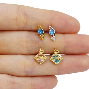 Close-up of nose stud set with star pendants and heart-shaped zircon in gold and silver finish