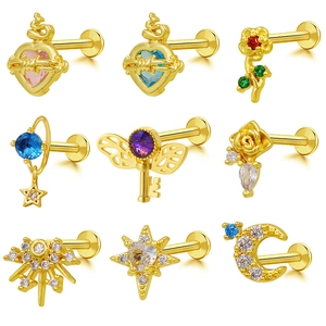 Detailed set of gold lip studs featuring zircon inlays of hearts, flowers, and moon shapes
