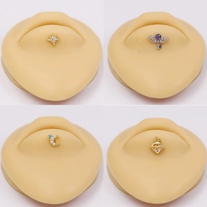 Set of four geometric ear and lip studs featuring star moon heart and wing designs