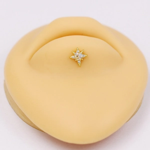 Macro shot of an octagonal star piercing with clear zircon on a silicone model