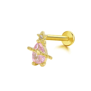 Detail of a gold labret stud with a pink pear gemstone and a small hanging star charm