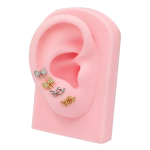 Set de cuatro pendientes de lazo y mariposa con circonitas rosas en oro y plata