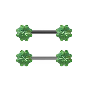 Macro shot of silver body piercing rings with green clover-shaped crystals in a set of two