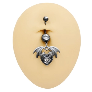 Gothic black belly button ring with heart-shaped gemstone and bat wings on silicone model
