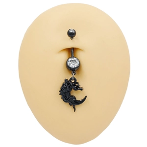 Close-up of black dragon and crescent moon belly button ring with crystal on silicone model