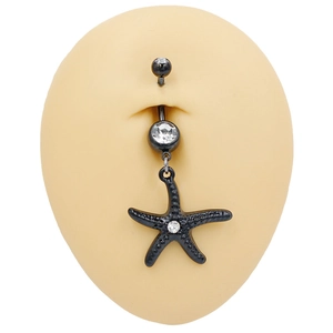 Macro shot of black starfish belly button ring with white rhinestones on model