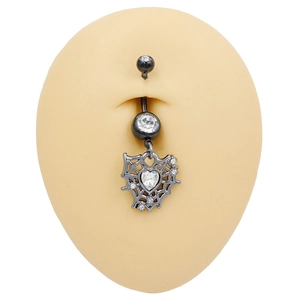 Macro shot of gothic spider web heart navel ring with crystals on a silicone model