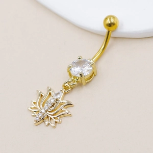 Macro view of gold lotus navel ring featuring a sparkling cross and pavé zirconia stones