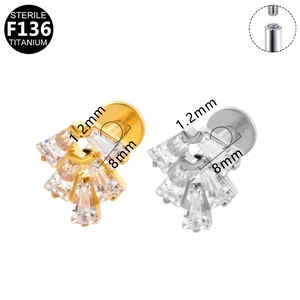 Detailed macro view of F136 titanium labret studs with baguette zircon fan design