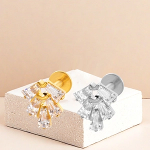 Macro detail of F136 titanium labret studs with fan-shaped zirconia in gold and silver