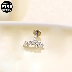 Macro shot of F136 titanium labret with five marquise-cut white zircons arranged in a curve