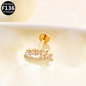 Macro detail of F136 titanium labret stud featuring 5 marquise-cut marquise-cut cubic zirconia
