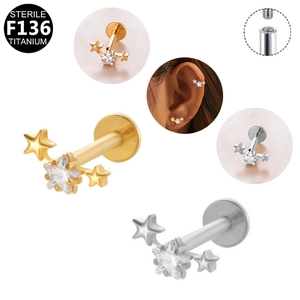 Detail of star-shaped F136 titanium earrings with cubic zirconia and internal threading