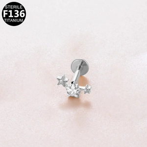 Detailed macro view of F136 titanium triple star labret stud with zircon stone