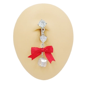 Detailed view of navel ring with red ribbon bow and heart cubic zirconia on model
