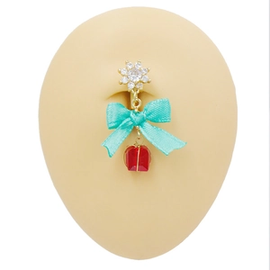Macro detail of navel ring featuring a red gemstone pendant and blue ribbon bow