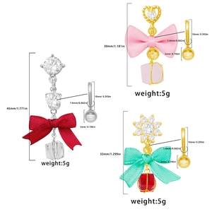 Three bowknot belly button rings with ribbons and heart-shaped cubic zirconia crystals