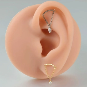 Detail of G23 titanium chain earring with marquise zircon on a silicone ear model