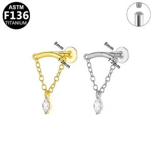 Detailed view of G23 titanium labret studs with marquise zircon and hanging chain