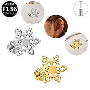 Macro detail of snowflake zircon ear studs in F136 titanium showing precise engravings