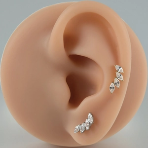 Marquise-cut zircon ear crawlers in gold and silver finish on silicone model