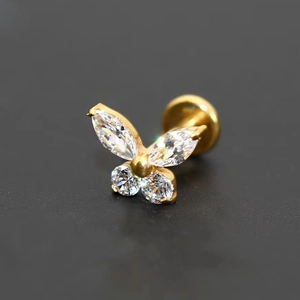 Close-up of golden titanium butterfly stud earring with marquise and round zircon stones