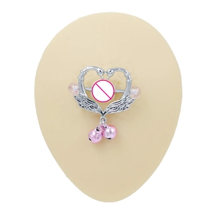 Detail of heart-shaped swan nipple shield with pink bells on a silicone model