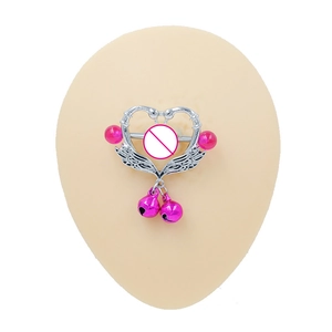 Winged heart nipple ring with pink bells and beads on a silicone model display