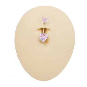Detailed view of pink heart navel ring with devil horns on skin-tone silicone model
