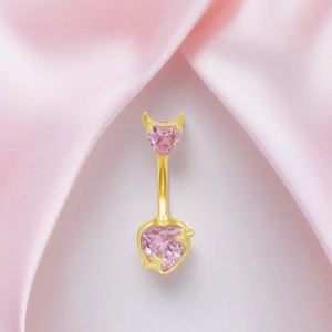 Pink heart-shaped belly button ring with devil horns and star details in gold finish