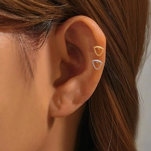 Detailed view of titanium labret stud with dangling fine chain on ear cartilage