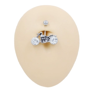 Detail of a motorcycle navel piercing ring featuring two large sparkling crystals on a model