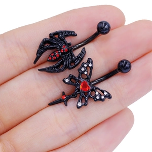 Gothic black spider and butterfly navel rings with red rhinestones on hand